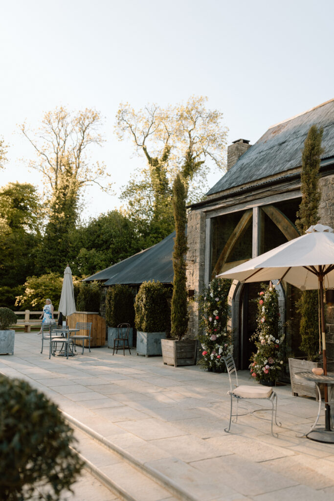 Guests enjoying cocktails on the new terrace at Cripps Barn during the outdoor drinks reception.