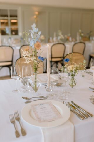 pastel floral centrepieces and elegant table styling.