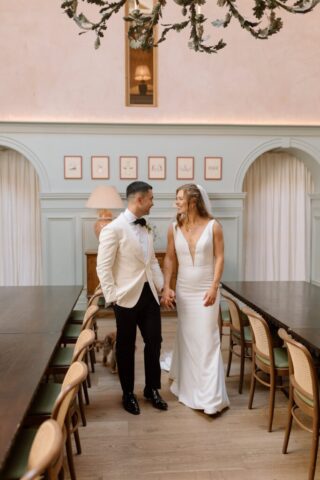 Newlywed couple taking stroll indoors at Kin House