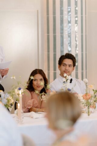 Candid photography of guests listening to the toasts