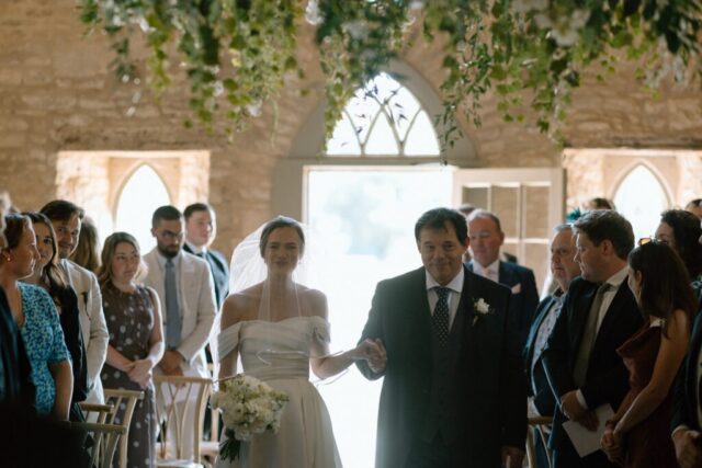 Bride in Milla Nova dress walking down the aisle at Ivy Lodge with her dad