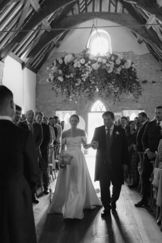 Bride in Milla Nova dress walking down the aisle at Ivy Lodge with her dad